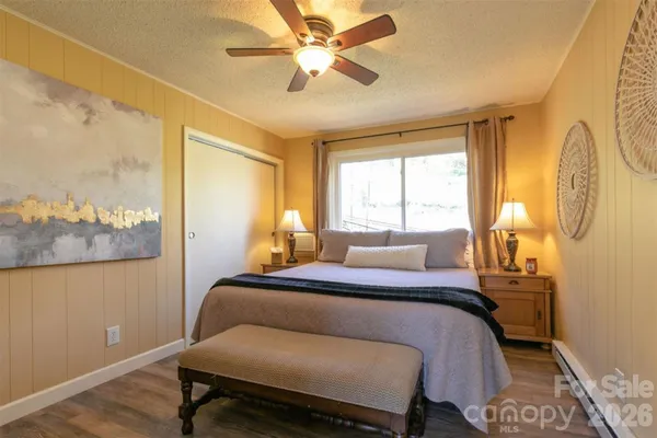 a bedroom with a bed and wooden floor