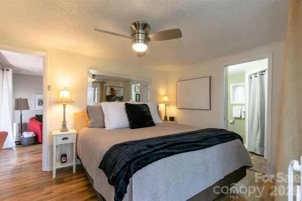 a bedroom with a bed and a chandelier