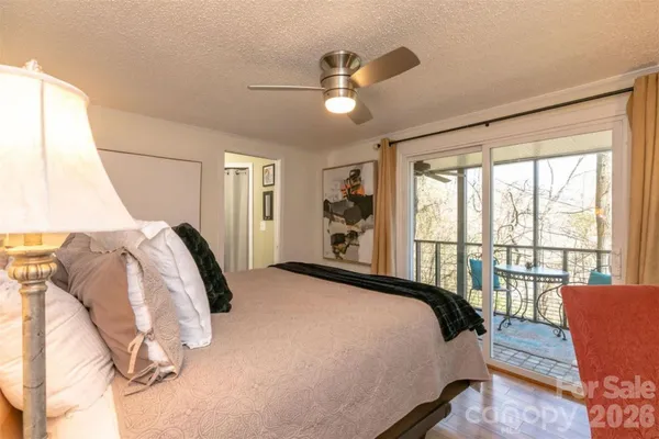 a bedroom with a bed and glass window