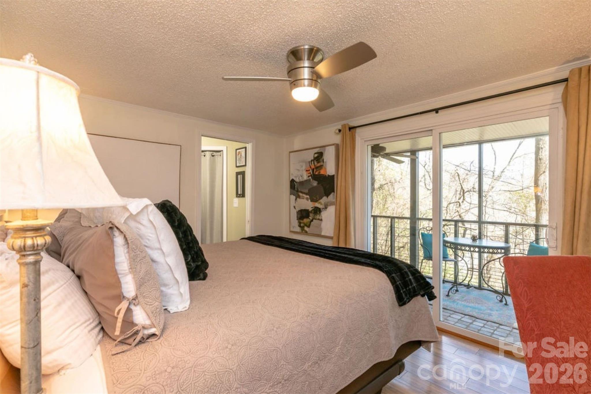 7 North Delano Road Asheville, NC 28805 - Photo 23 of 32 a bedroom with a bed and glass window