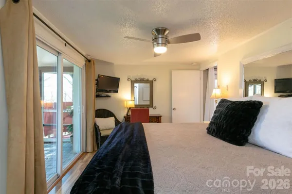 a bedroom with a bed and a large mirror