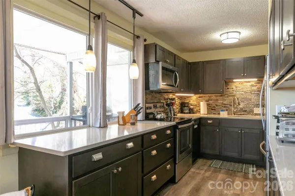 a kitchen with a sink window and cabinets