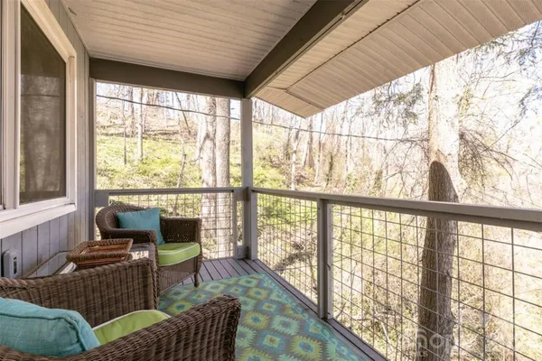 a balcony with furniture and a potted plant