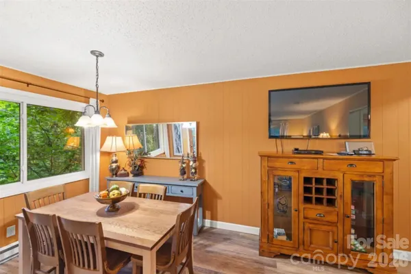 a dining room with furniture window and outside view