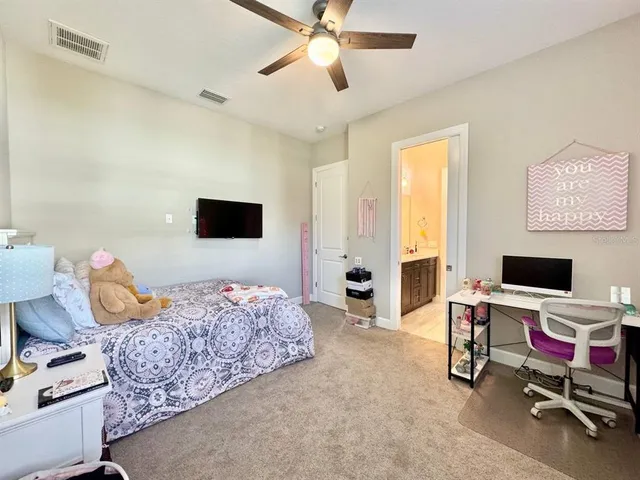 a spacious bedroom with a large bed and a flat screen tv