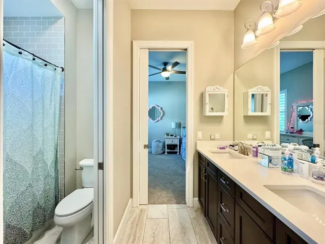 a spacious bedroom with a bed a window and a flat screen television