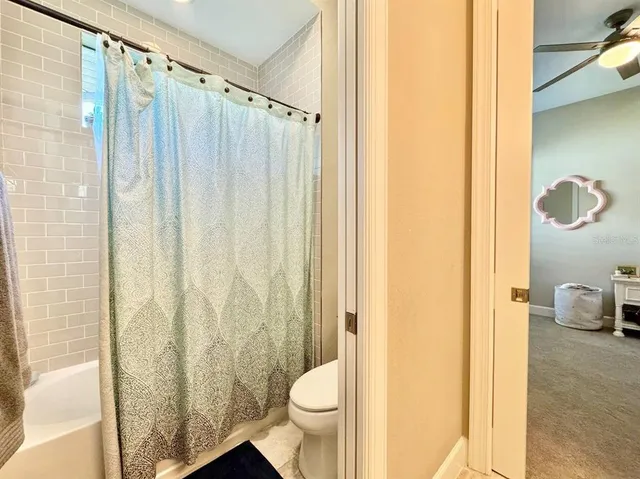 a white bath tub sitting next to a bathroom sink