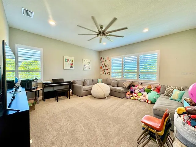 a view of a patio with a table and chairs and potted plants