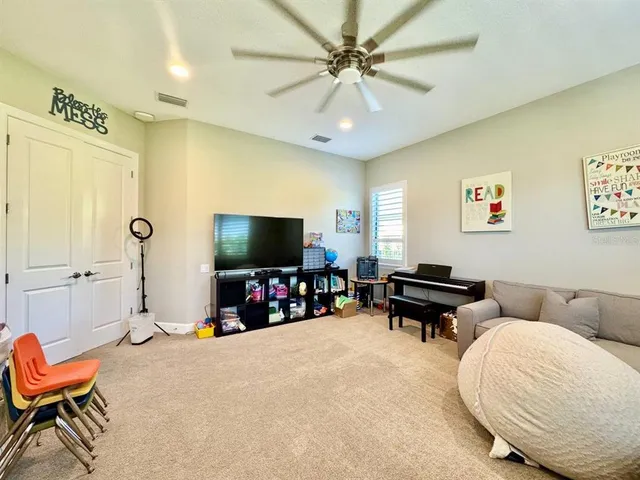 a view of a dining room and livingroom with furniture wooden floor a chandelier