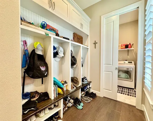 a view of a swimming pool with a lawn chairs under palm trees
