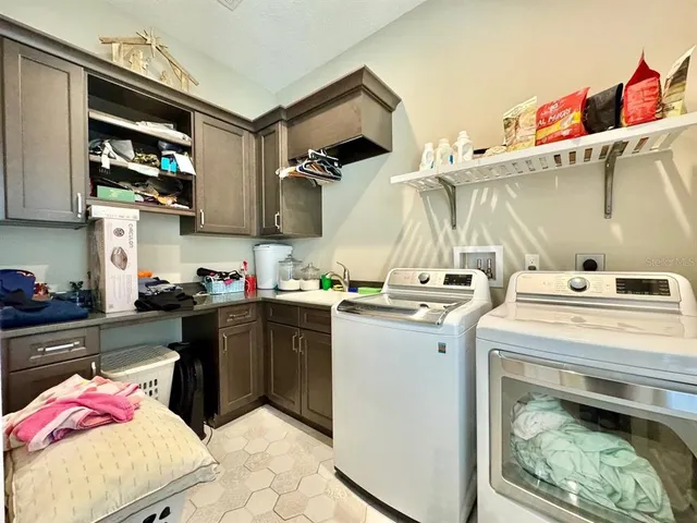 a view of a swimming pool with a lawn chair and palm trees