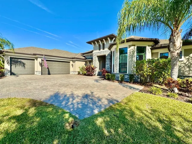 a view of a house with a swimming pool and a yard