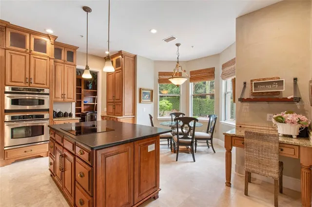 a kitchen with stainless steel appliances granite countertop a stove a sink and a refrigerator
