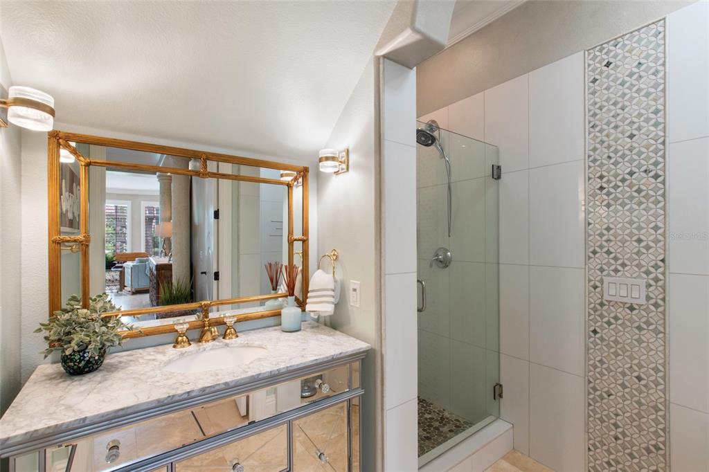 248 Maison Court Altamonte Springs, FL 32714 - Photo 14 of 47 a bathroom with a granite countertop sink a large mirror and a shower