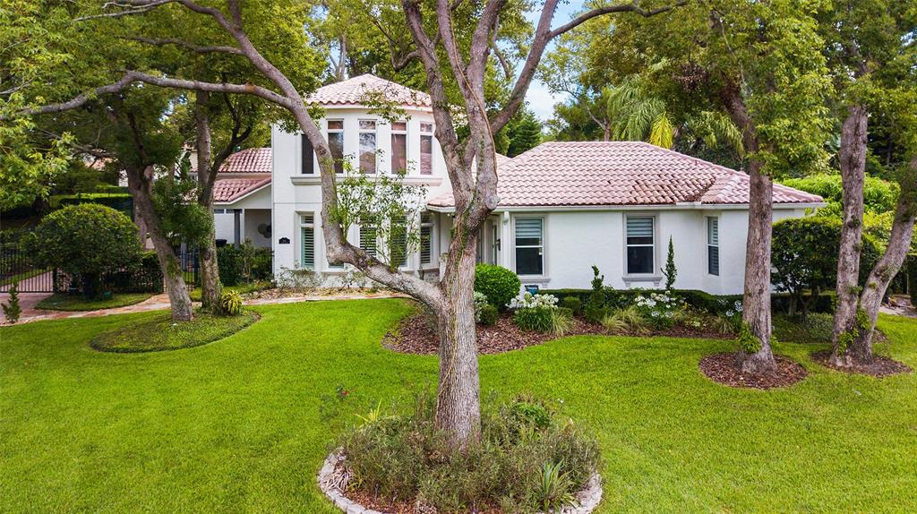 248 Maison Court Altamonte Springs, FL 32714 - Photo 2 of 47 a front view of a house with a yard table and chairs