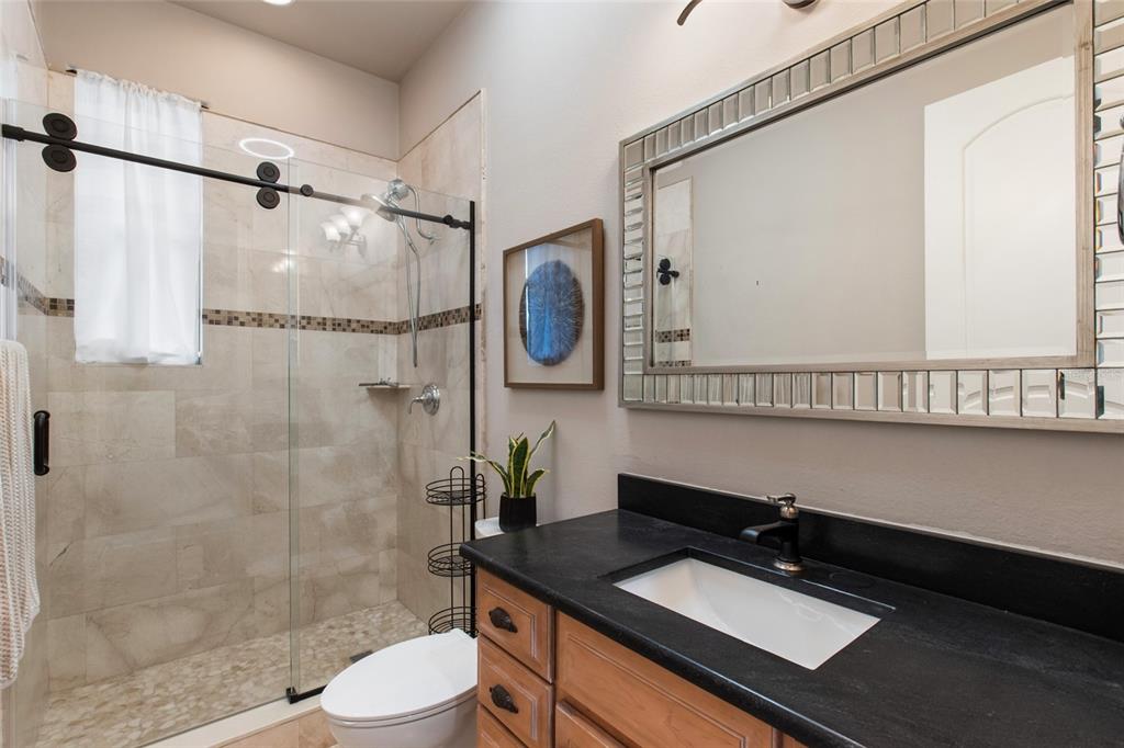 248 Maison Court Altamonte Springs, FL 32714 - Photo 28 of 47 a bathroom with a granite countertop sink toilet a mirror and shower