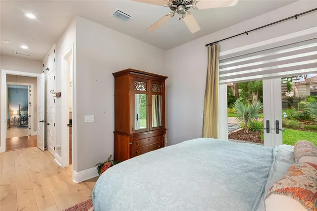 a bedroom with a bed and a chandelier