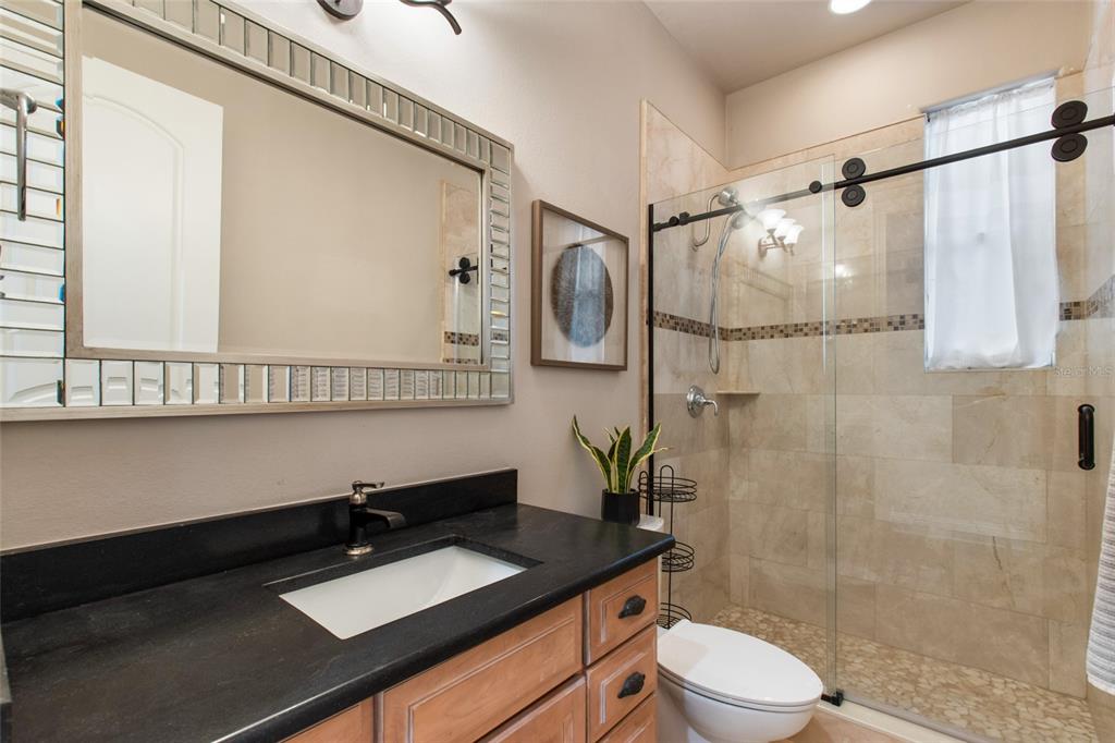 248 Maison Court Altamonte Springs, FL 32714 - Photo 31 of 47 a bathroom with a granite countertop sink toilet a mirror and shower