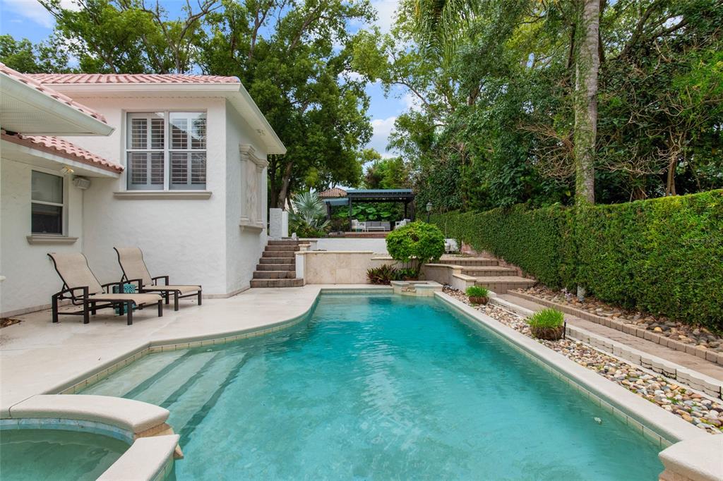 248 Maison Court Altamonte Springs, FL 32714 - Photo 37 of 47 a view of a patio with table and chairs potted plants and large tree