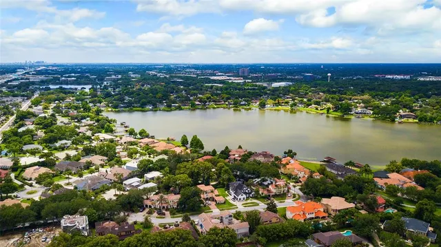 an aerial view of residential house with yard and outdoor seating