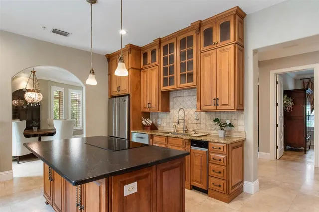 a kitchen with sink cabinets and refrigerator