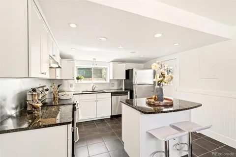 a kitchen with a sink cabinets and stove top oven