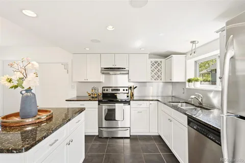 a kitchen with a sink stove and cabinets