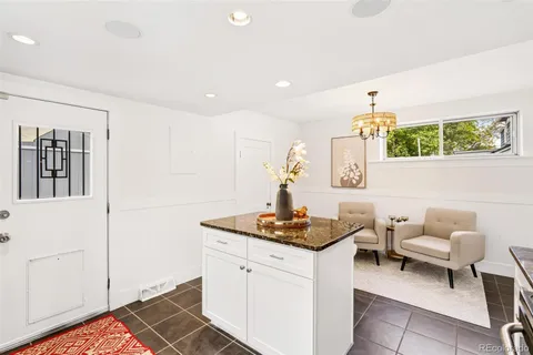 a kitchen with a sink cabinets and wooden floor