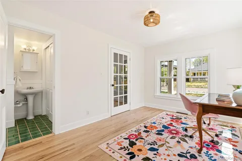 a view of an empty room with window and wooden floor
