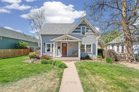 a front view of a house with garden and porch