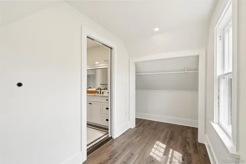 a view of hallway with wooden floor