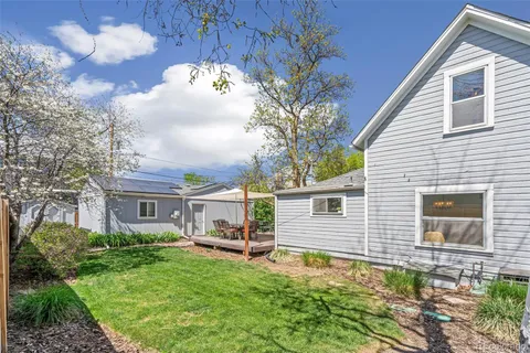 a view of house with backyard