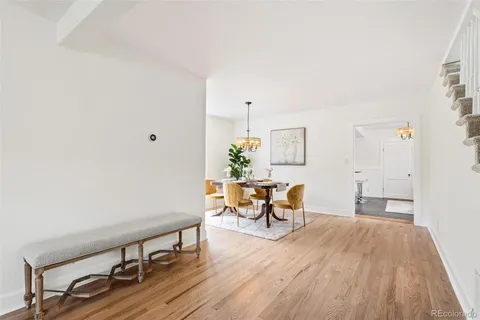a view of a room with wooden floor and furniture