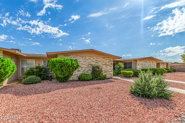 a view of a garden with a building in the background