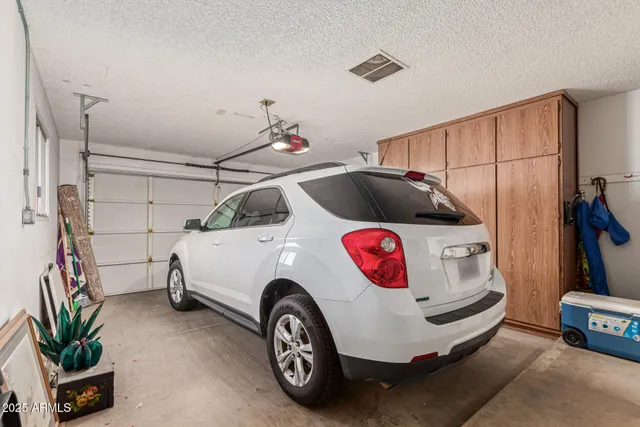 a car parked in front of a building with an ocean view
