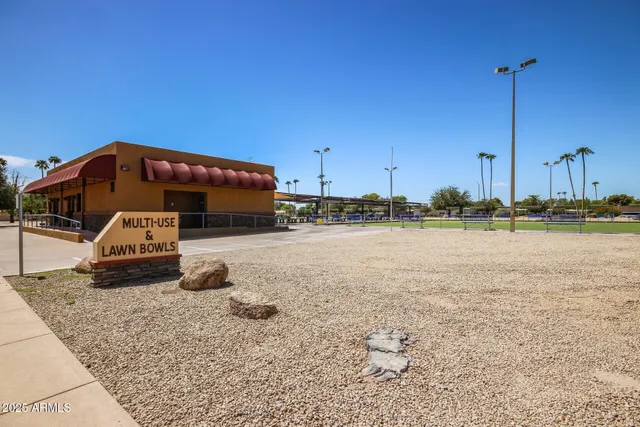 a view of a swimming pool with a table and chairs under an umbrella