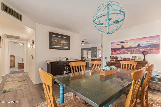 a living room with furniture kitchen view and a large window