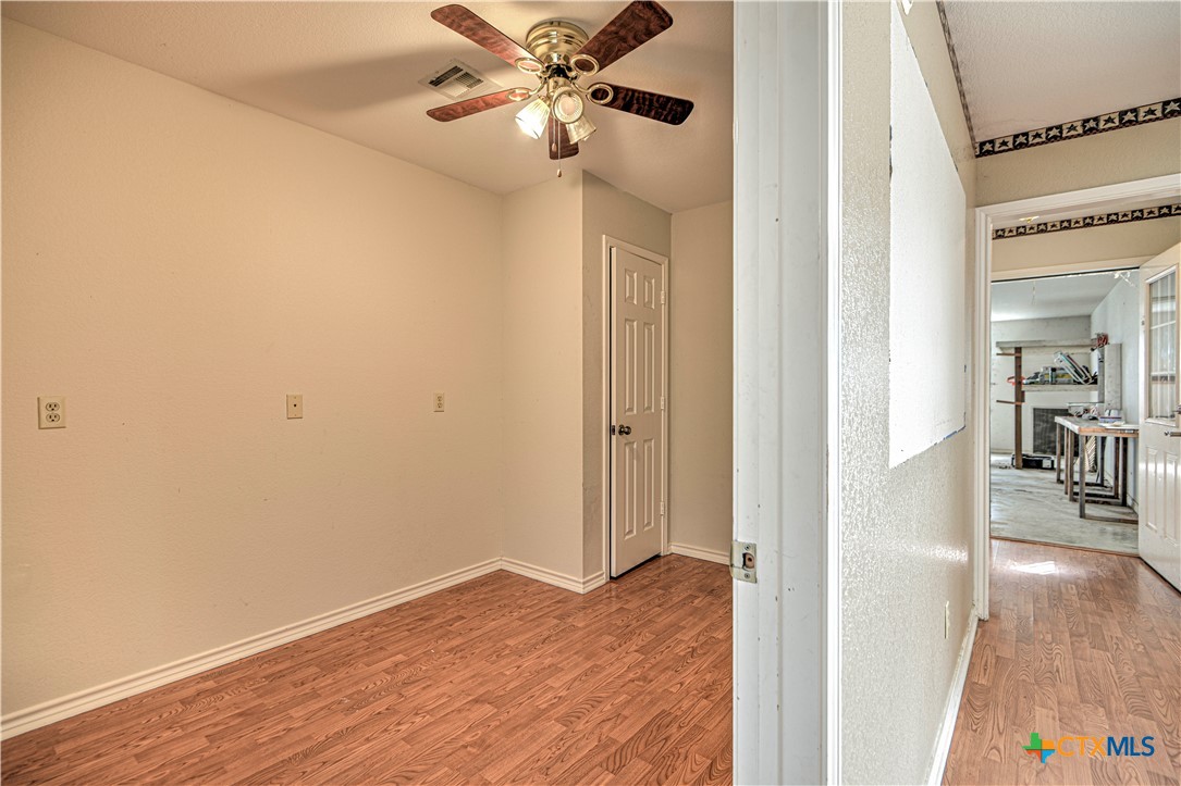 809 Hudson Lane Eddy, TX 76524 - Photo 16 of 48 a view of a hallway with wooden floor
