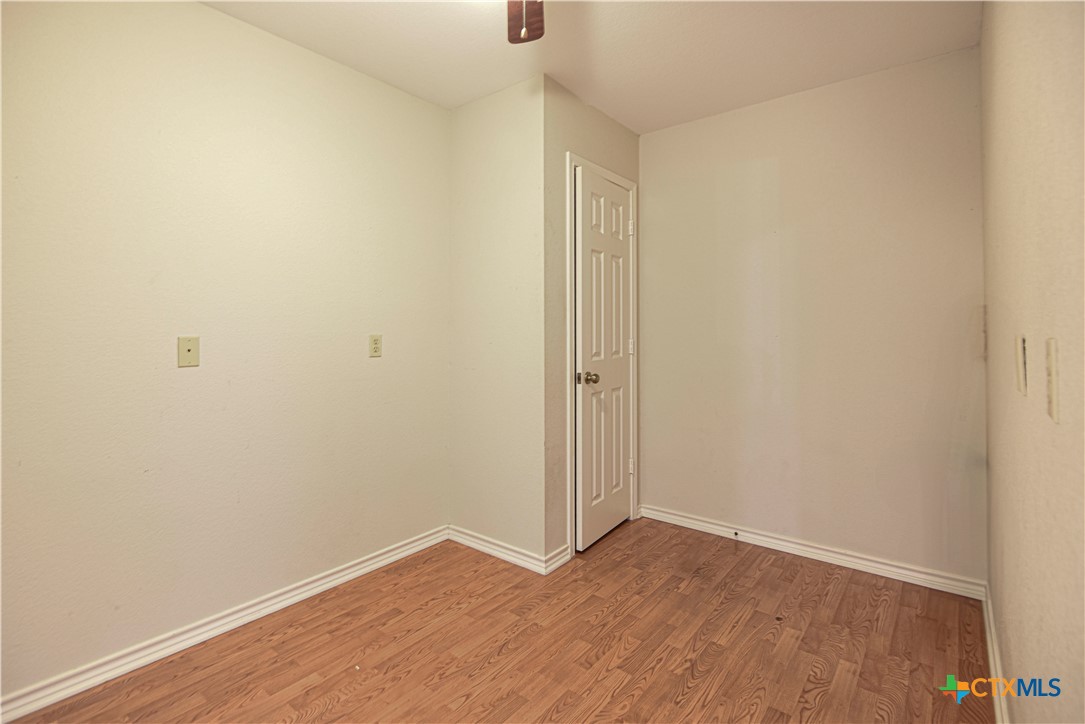 809 Hudson Lane Eddy, TX 76524 - Photo 18 of 48 a view of an empty room with wooden floor