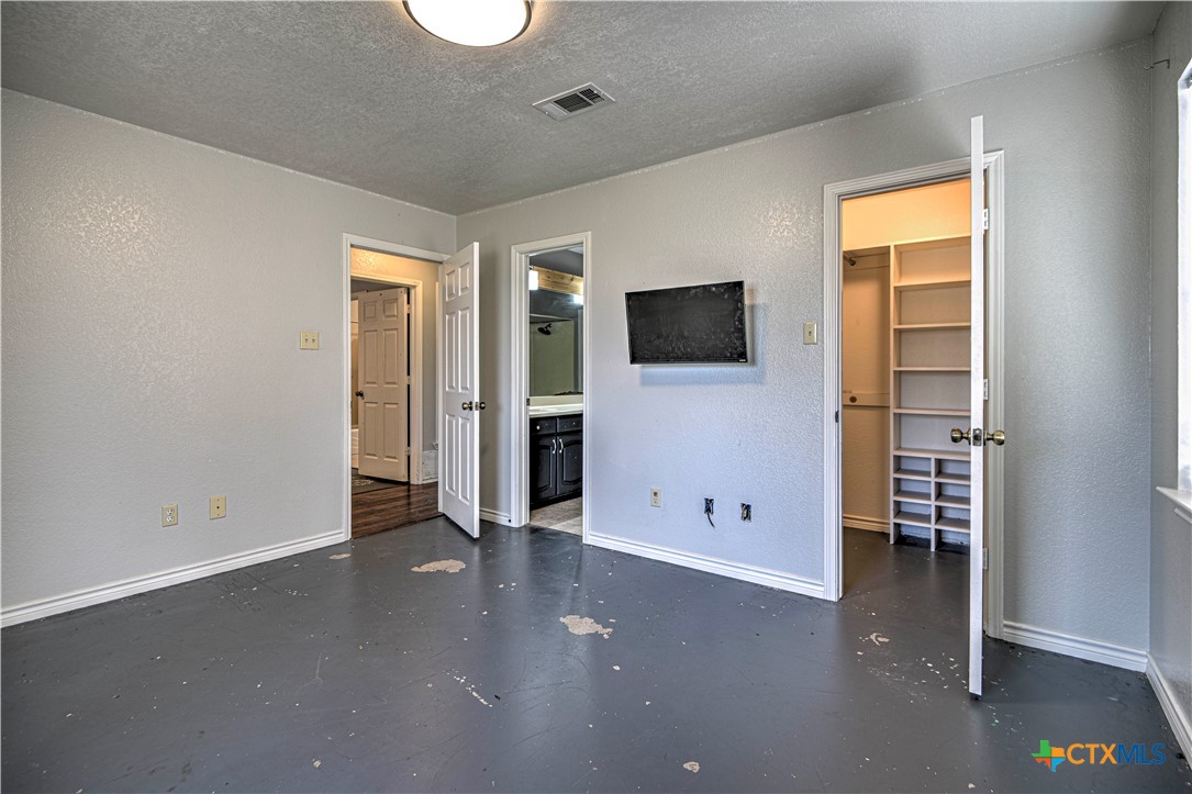809 Hudson Lane Eddy, TX 76524 - Photo 32 of 48 an empty room with windows cabinet and flat screen tv
