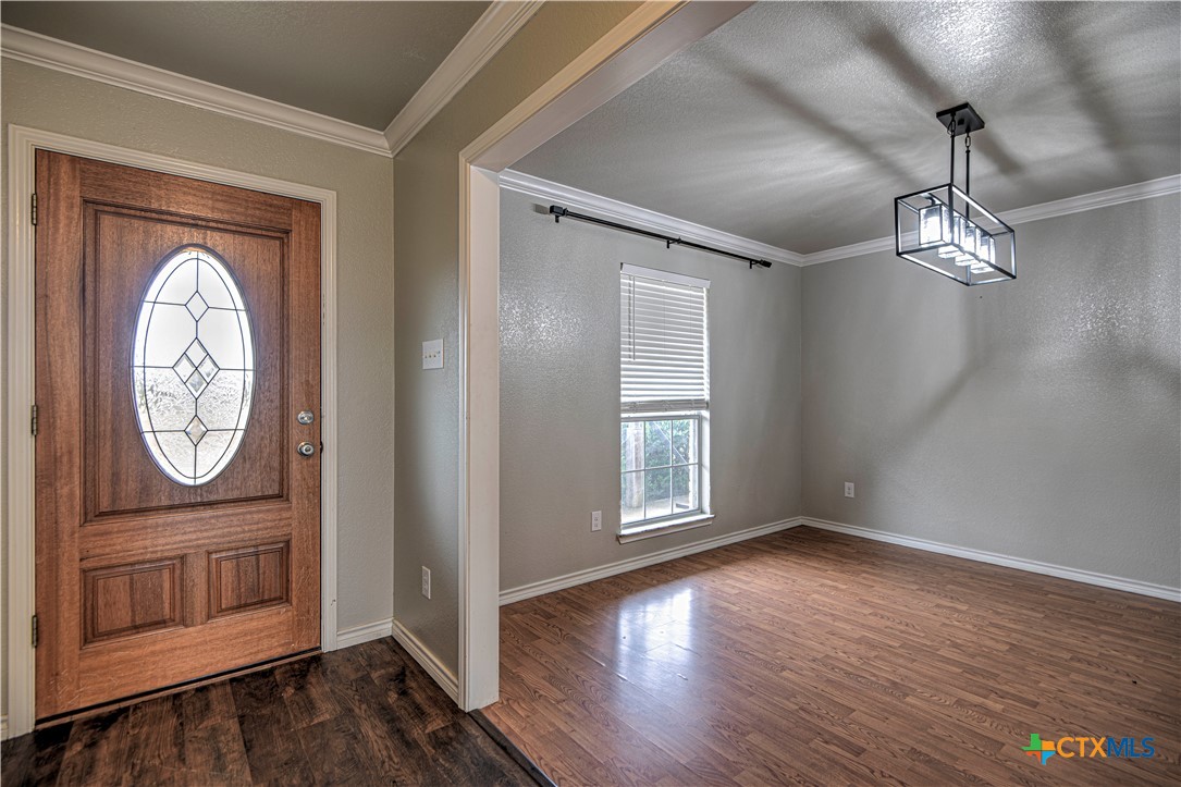 809 Hudson Lane Eddy, TX 76524 - Photo 5 of 48 a view of an empty room with wooden floor and a window