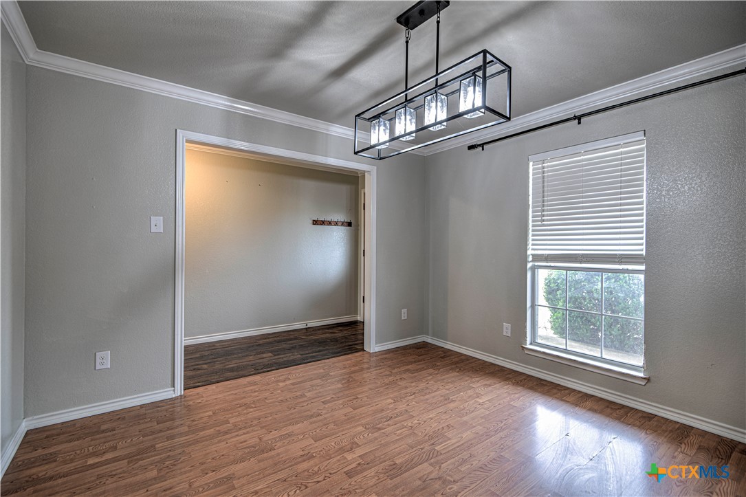 809 Hudson Lane Eddy, TX 76524 - Photo 8 of 48 an empty room with wooden floor door and windows