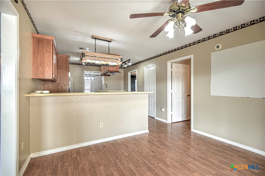 809 Hudson Lane Eddy, TX 76524 - Photo 10 of 48 a view of a kitchen with a dishwasher cabinets and wooden floor