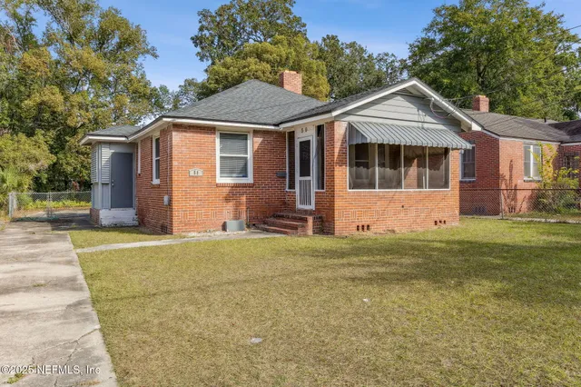 a front view of a house with a garden