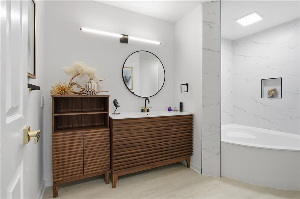 970 Sidney Marcus Boulevard Northeast, Unit 2203 Atlanta, GA 30324 - Photo 15 of 39 a bathroom with a sink and a mirror