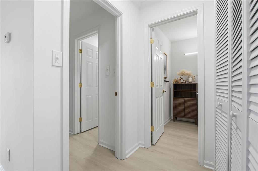 970 Sidney Marcus Boulevard Northeast, Unit 2203 Atlanta, GA 30324 - Photo 19 of 39 a view of a hallway with bathroom and a sink