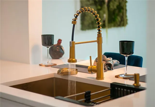 a kitchen with stainless steel appliances a refrigerator and a stove top oven