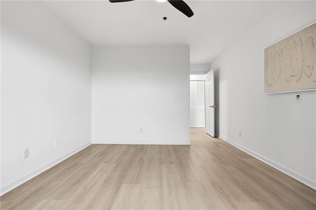 970 Sidney Marcus Boulevard Northeast, Unit 2203 Atlanta, GA 30324 - Photo 24 of 39 an empty room with wooden floor and windows