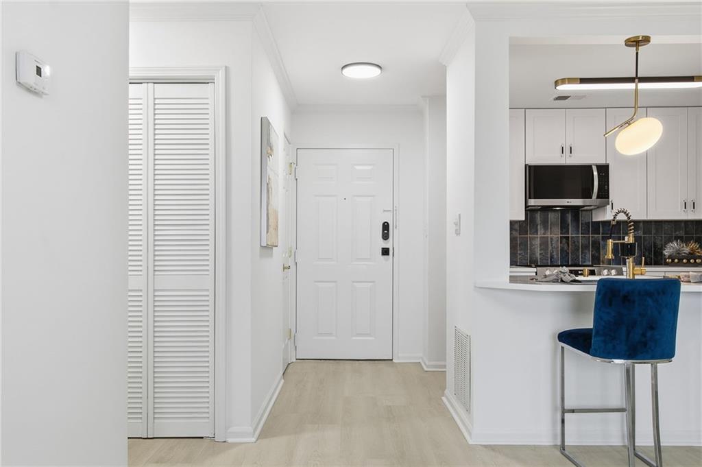 970 Sidney Marcus Boulevard Northeast, Unit 2203 Atlanta, GA 30324 - Photo 3 of 39 a kitchen with stainless steel appliances a refrigerator and a stove top oven
