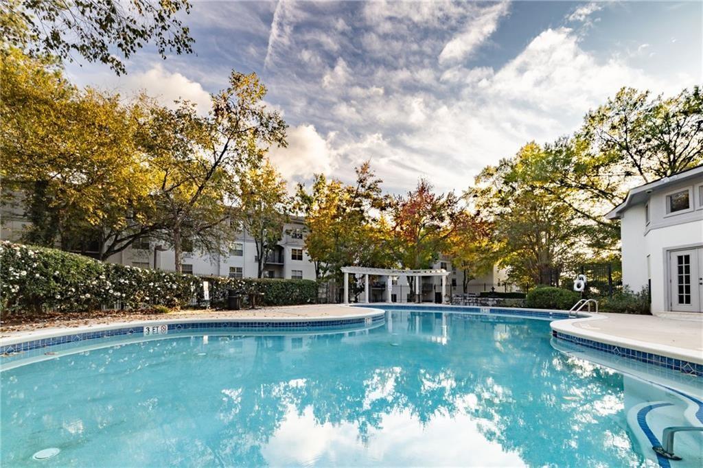 970 Sidney Marcus Boulevard Northeast, Unit 2203 Atlanta, GA 30324 - Photo 31 of 39 a view of house with swimming pool and trees in the background